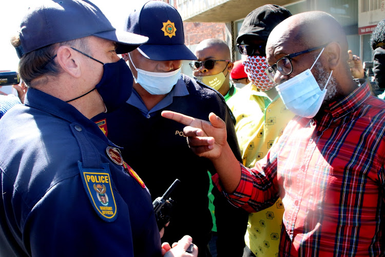 ANC Nelson Mandela Bay councillor Makhi Feni address policemen who wanted a group of ANC members to disperse outside Florence Matomela House