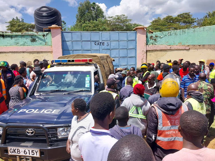 Police at the scene where the woman killed her two children in Eldoret