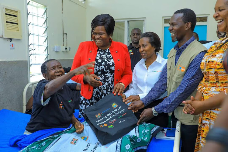 Homa Bay Governor Gladys Wanga with M-Pesa Foundation Trustee Anne Erickson and Roslyn Omollo gift a woman at Homa Bay Referral hospital on October 26,2023