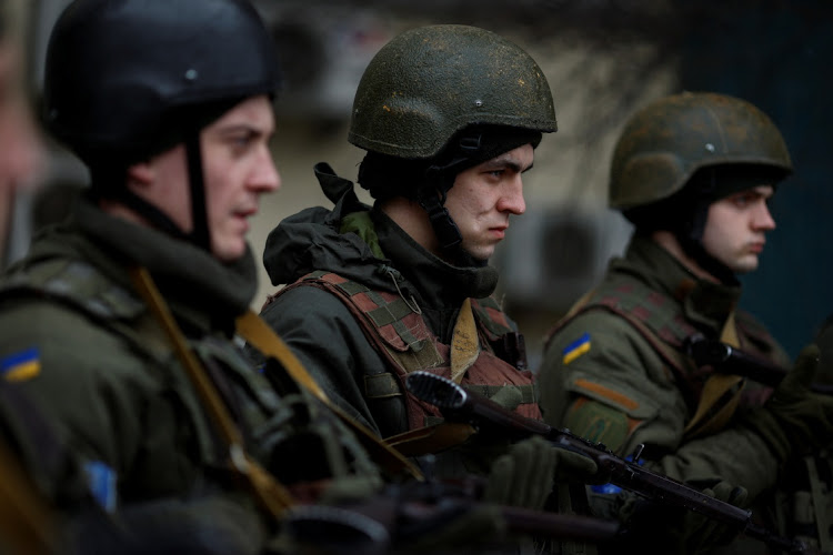 Ukrainian servicemen attend a prayer service before going into battle, as Russia's attack on the Ukraine continues, in Kyiv, Ukraine, March 13, 2022. Picture: THOMAS PETER/REUTERS