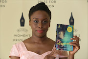 Author Chimamanda Ngozi Adichie poses with her novel 