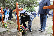 Western Cape police commissioner Lt-Gen Thembisile Patekile lays a wreath at Sea Point police station during a memorial service on May 13 2022 for Const Donay Delano Phillips, who was shot at the New Somerset Hospital on Saturday. 