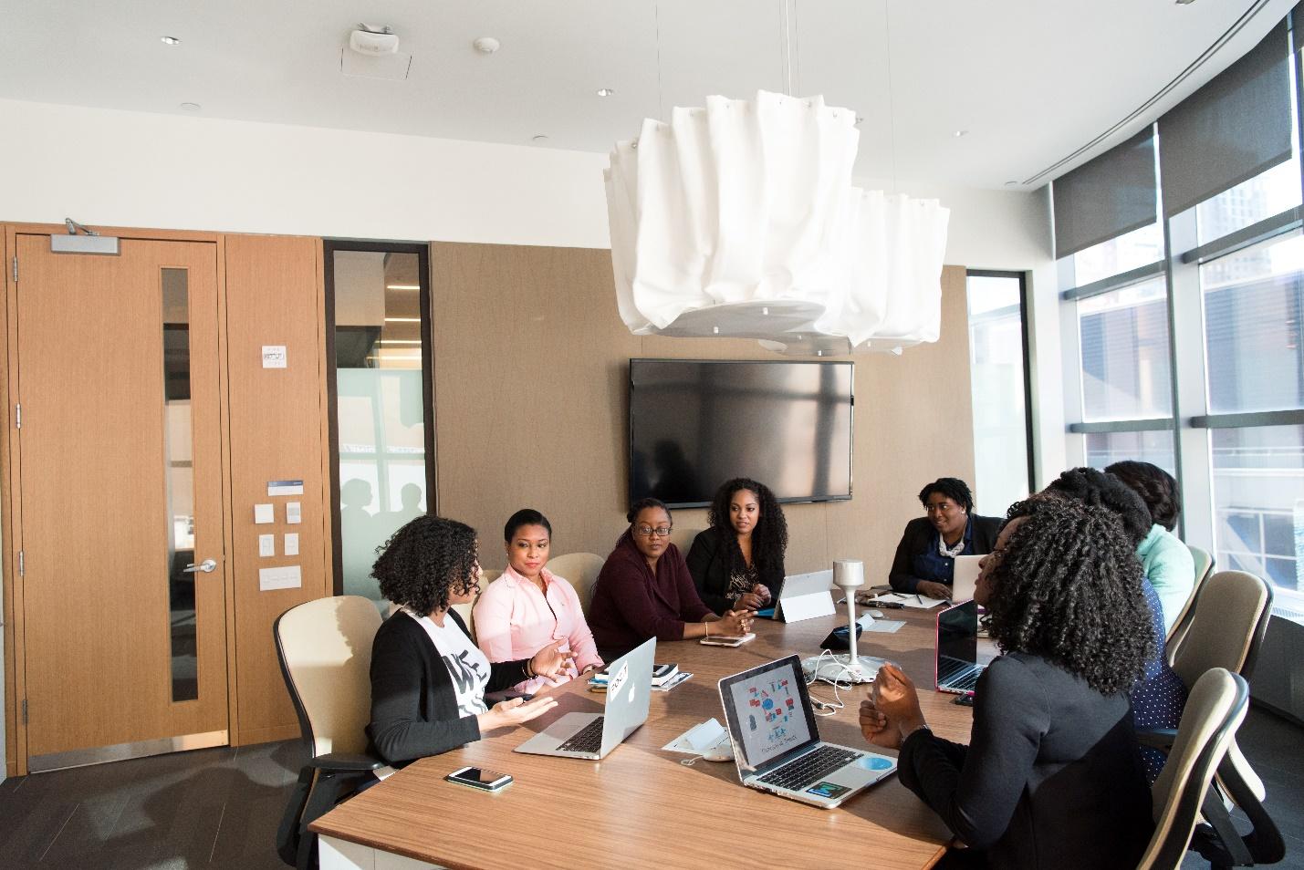 A group of people sitting around a table

Description automatically generated with medium confidence