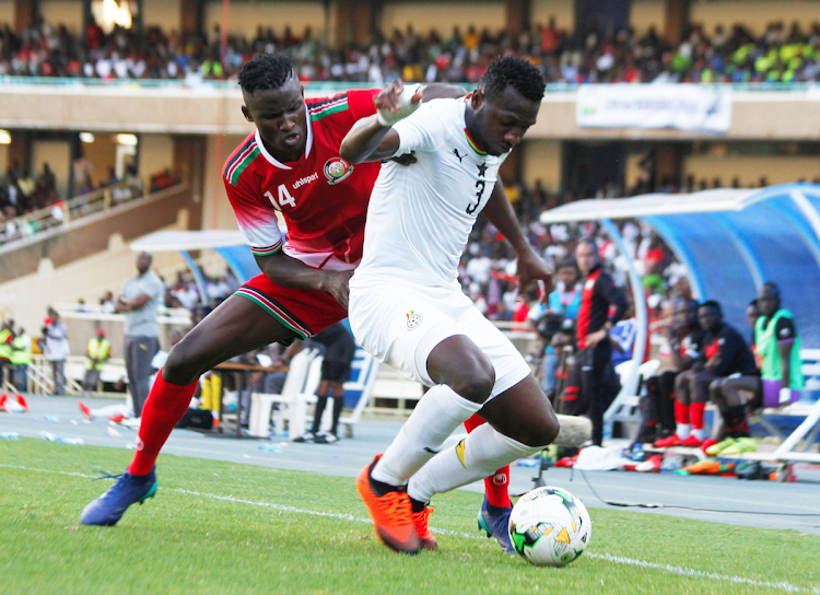 Harambee Stars striker Michael Olunga (L) challenges Ghana defender Nicholas Opoku during a Cup of Nations qualifying match at Moi Stadium, Kasarani on September 8, 2018