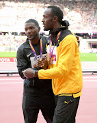 Justin Gatlin of the United States, gold, and Usain Bolt of Jamaica, bronze, celebrate during the medal ceremony for the Men's 100 metres during day three of the IAAF World Athletics Championships at the London Stadium on August 6, 2017 in London, United Kingdom. 