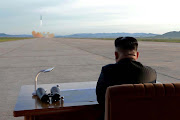 North Korean leader Kim Jong Un watches the launch of a Hwasong-12 missile in this undated photo released by North Korea's Korean Central News Agency (KCNA) on September 16, 2017. 