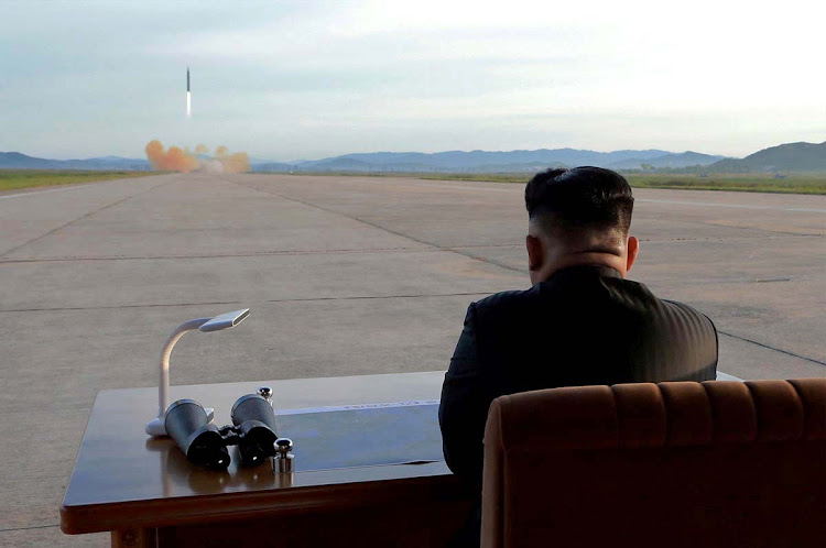 North Korean leader Kim Jong Un watches the launch of a Hwasong-12 missile in this undated photo released by North Korea's Korean Central News Agency (KCNA) on September 16, 2017.