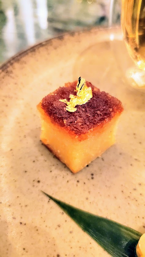 Homemade Traditional Nyonya Kuehs an Sweets with Bunga Telang Tea as part of an Ahma-kase Dinner at Candlenut for Peranakan Food: Kueh Bingkah, traditional tapioca cake topped with caramelized coconut