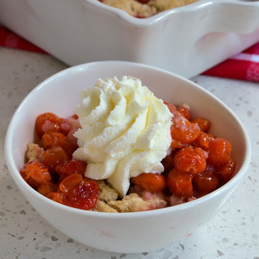 This Homemade Cherry Cobbler made with fresh cherries and an easy flaky buttery biscuit topping hits the spot every time.  Enjoy with fresh whipped cream or with real vanilla ice cream.