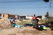 Women do laundry in Setjwetla informal settlement in Alexandra 