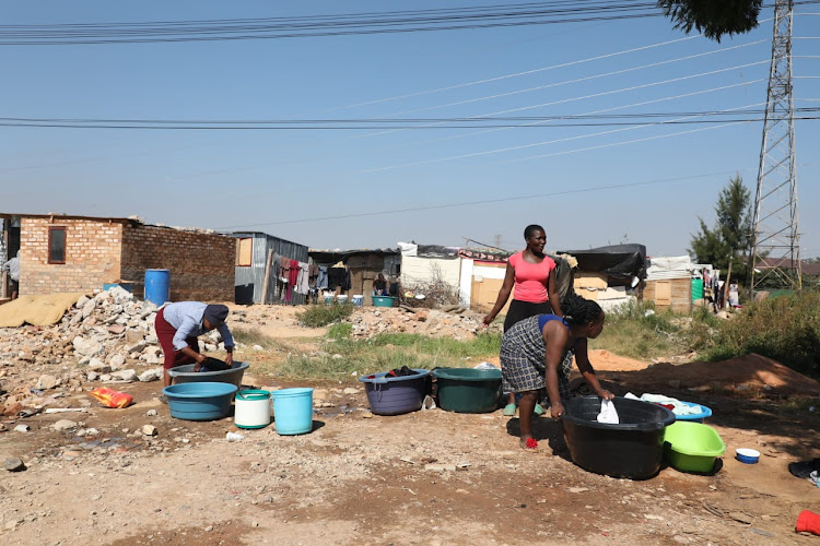 Women do laundry in Setjwetla informal settlement in Alexandra amid the Covid-19 pandemic