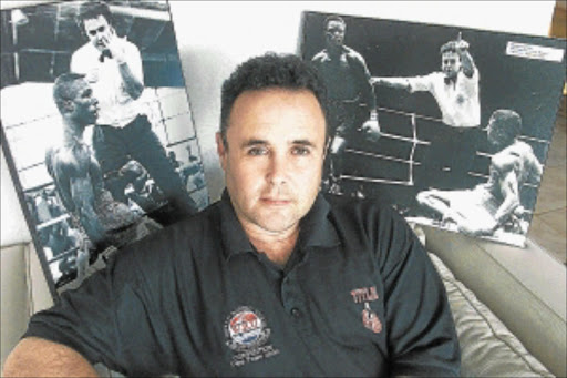 PROUD: World Boxing Federation president Howard Goldberg looks on with pride at pictures of previous fights in which he has officiated. PHOTO: Terry Shean