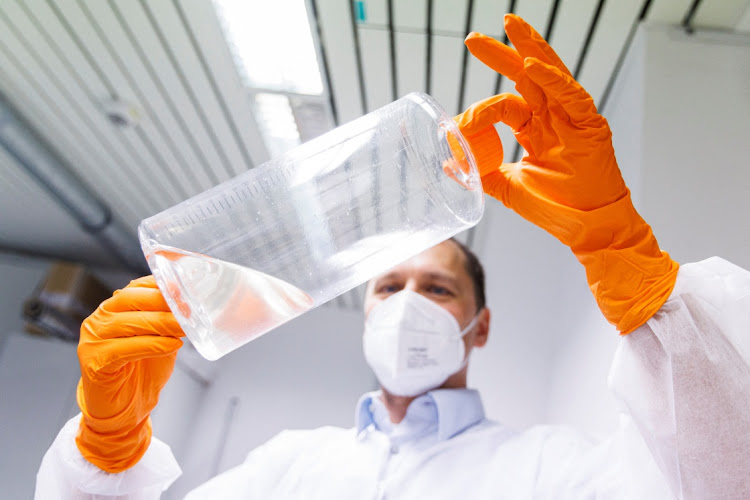 An employee of the vaccine company Bavarian Nordic shows a container with fibroblast cells from chicken embryos for the propagation of vaccine viruses in a laboratory of the company in Martinsried near Munich, Germany, May 24, 2022.