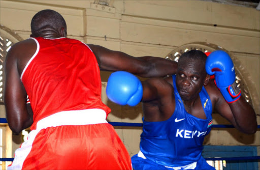 Daniel Shisia of Kenya Prisons(R) evades a punch from Antony Kinoti of Kenya police during the All Africa Games trials at Kaloleni social hall during the weekend.PHOTO-ERICK BARASA