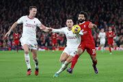 Jonny Evans and Diogo Dalot of Manchester United battle for possession with Mohamed Salah of Liverpool in the Premier League match at Anfield in Liverpool on Sunday.