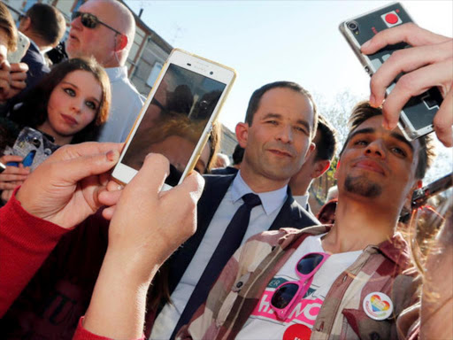 Benoit Hamon, Socialist Party presidential candidate for the 2017 presidential election, makes selfie with supporters after delivering a speech as he campaigns in Carmaux, France, April 21, 2017. /REUTERS