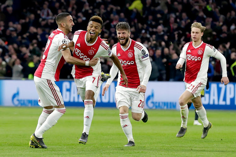 Ajax Amsterdam star David Neres celebrates with teammates after scoring the equaliser during the Uefa Champions League first leg quarterfinal match against Juventus in Amsterdam on April 10 2019.