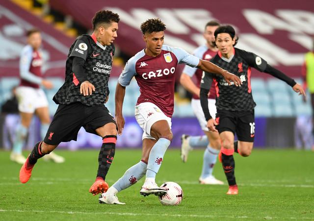 Aston Villa's Ollie Watkins in action with Liverpool's Roberto Firmino and Takumi Minamino