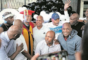 Bernard Lusozi, middle, is surrounded by other retired footballers who had come to his Soweto home to celebrate with him.