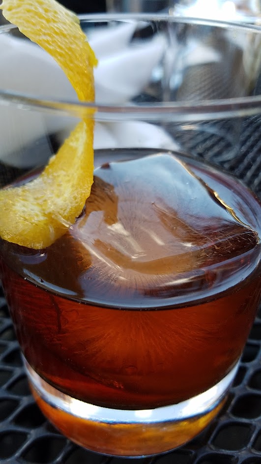 Negroni with Aria Gin, Cocchi Torino, Campari, and orange skin, one of six curated cocktails offered at Ken's Artisan Pizza