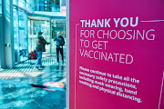 A health and safety information board for visitors who have received vaccines at the Discovery head office vaccination site in the Sandton business district of Johannesburg, South Africa, on Tuesday, July 27, 2021. 