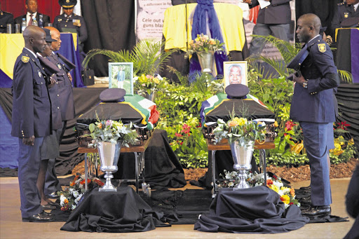 TRAGIC TIMES: Pallbearers prepare to carry the coffins of Lefu Mokoena and Bhekuyise Malalela at their joint funeral in Vosloorus, east of Johannesburg, in July Picture: KEVIN SUTHERLAND