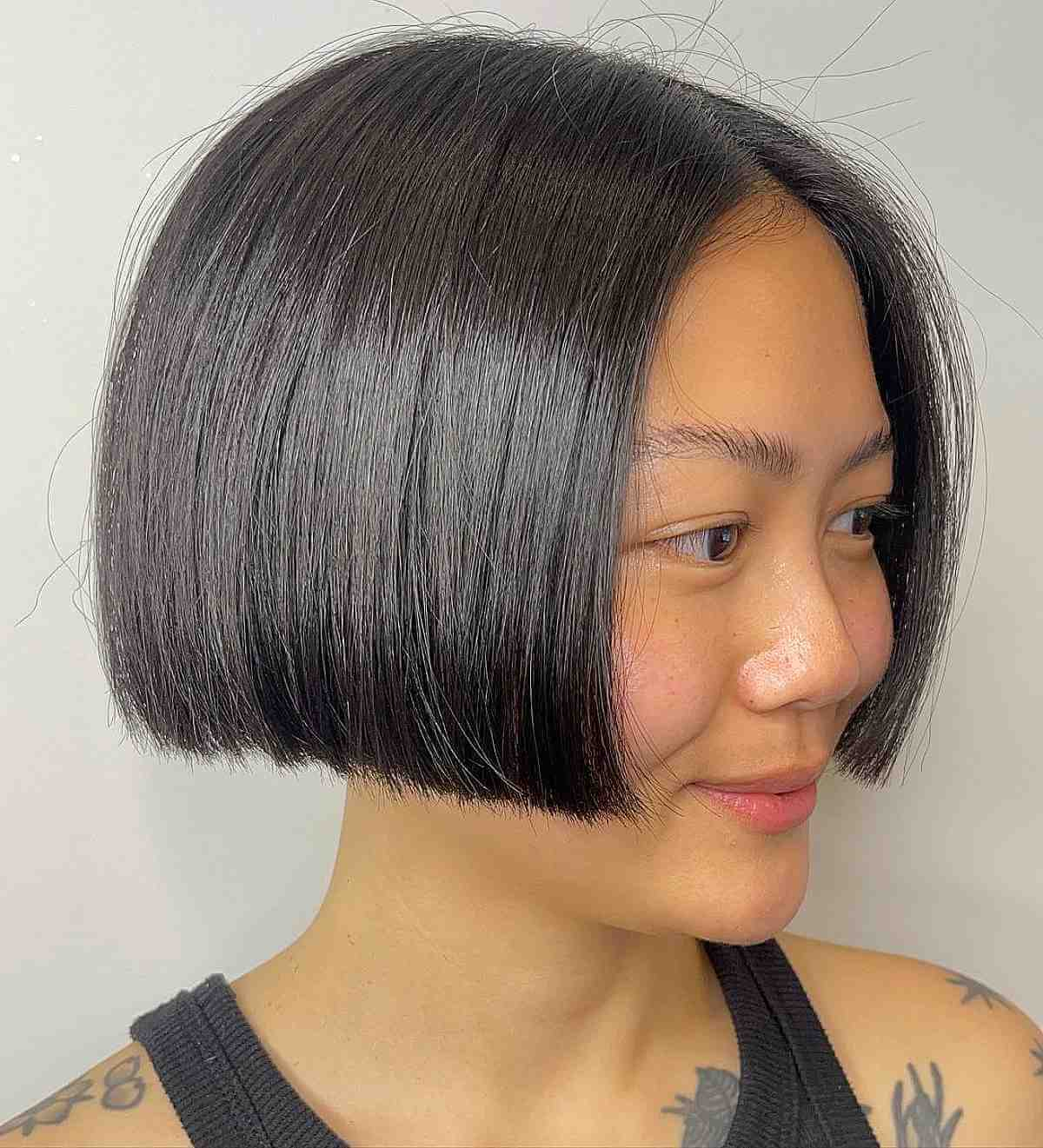 Asian lady wearing black blunt cut bob