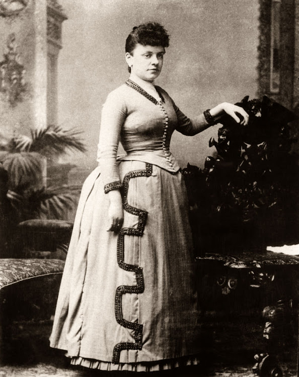 19th century woman in a bustle skirt.