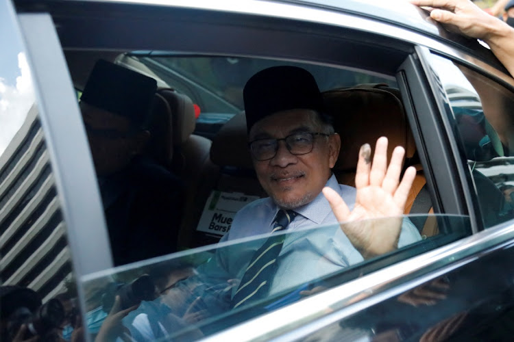 Anwar Ibrahim waves as he arrives at the National Palace, in Kuala Lumpur, Malaysia, on November 22 2022. Picture: REUTERS/HASNOOR HUSSAIN