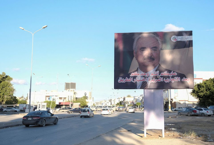 A billboard with an image of Libya's eastern commander and presidential candidate Khalifa Haftar is pictured by a roadside in Benghazi, Libya December 22, 2021