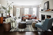 A cosy formal lounge setting with ample seating and warming layers arranged around the fireplace.