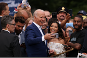 US President Joe Biden takes a selfie with attendees to a celebration of Independence Day at the White House, in Washington, US, on July 4 2021. 