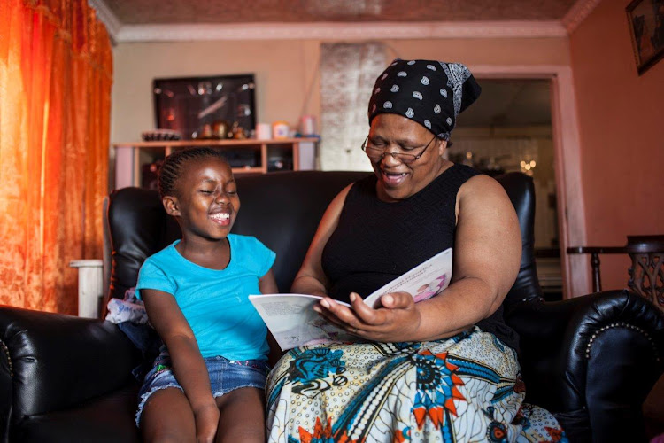 LOVE OF READING: Nomfanelo Bovu reads a story to her granddaughter, Olitha Mangcayi, during the national 21-day lockdown to instill good habits which will last after the lockdown is complete