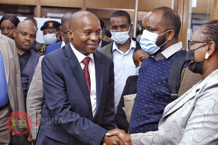 Interior CS Kithure Kindiki interacting with Kenyans at the Ministry of Immigration Nyayo House on November 29.