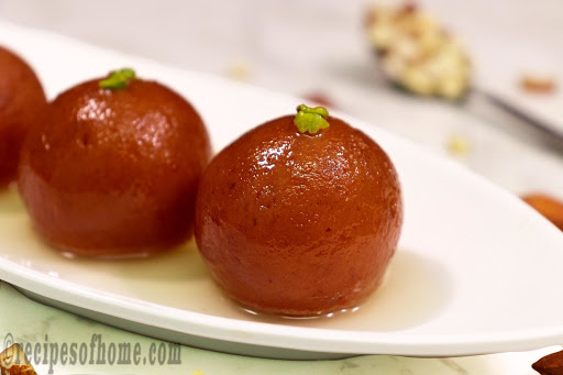 soft gulab jamun serving on white plate