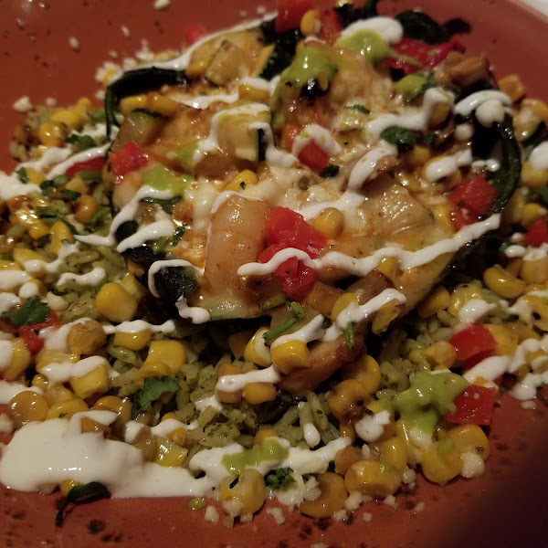 Chili relleno with shrimp,  mushrooms, and zucchini on a bed of cilantro lime rice and street corn.  Delicious!