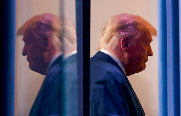 US President Donald Trump is reflected as he departs after speaking about the 2020 US presidential election results in the Brady Press Briefing Room at the White House in Washington, US, on November 5 2020.