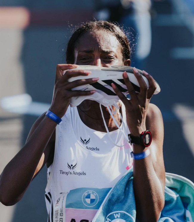 Ethiopia's Tigst Assefa kisses her Adizero Adios Pro Evo 1 after breaking the women's marathon world record in Berlin on September 24.