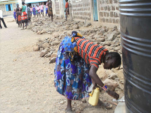 Pokot woman desperately opens a dry tap of a Kentank at Riongo Primary School in Tiaty, Baringo county on January 19