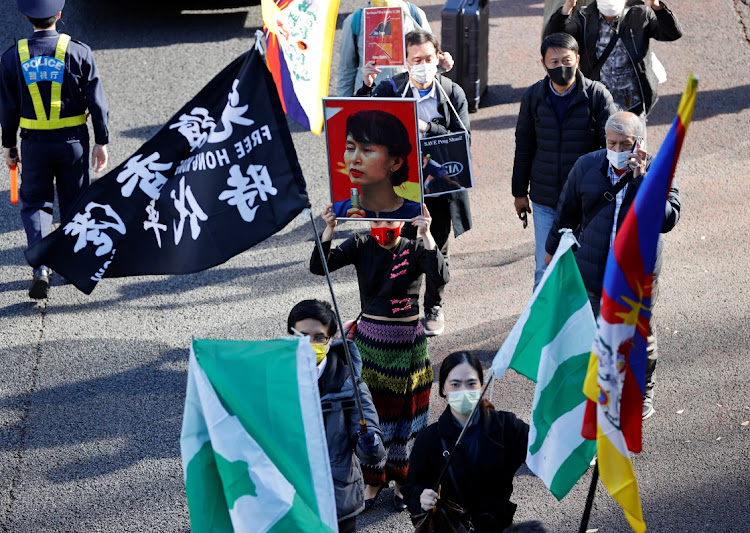 A protester holds an image of deposed Myanmar leader Aung San Suu Kyi during the a Human Rights Day march in Tokyo, Japan December 11 2021. Picture: ISSEI KATO/REUTERS