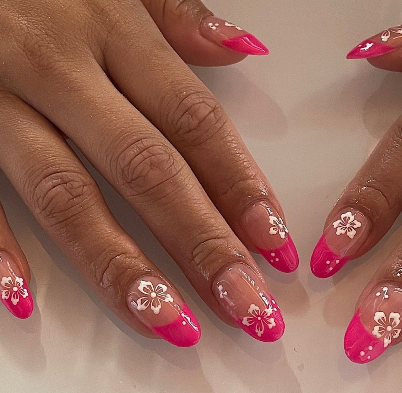 Pink french manicure summer nails with a white flower and nude