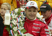 Gil de Ferran celebrates Indy 500 victory.
