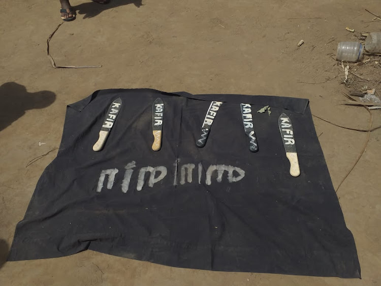 A flag and pangas with the word 'Kafir' embossed on them after a raid in Matuga on August 31.