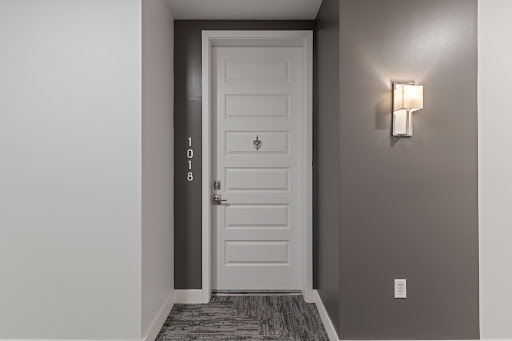Hallway with white door and wall sconce in this luxury property for sale in Scottsdale ($599,000)