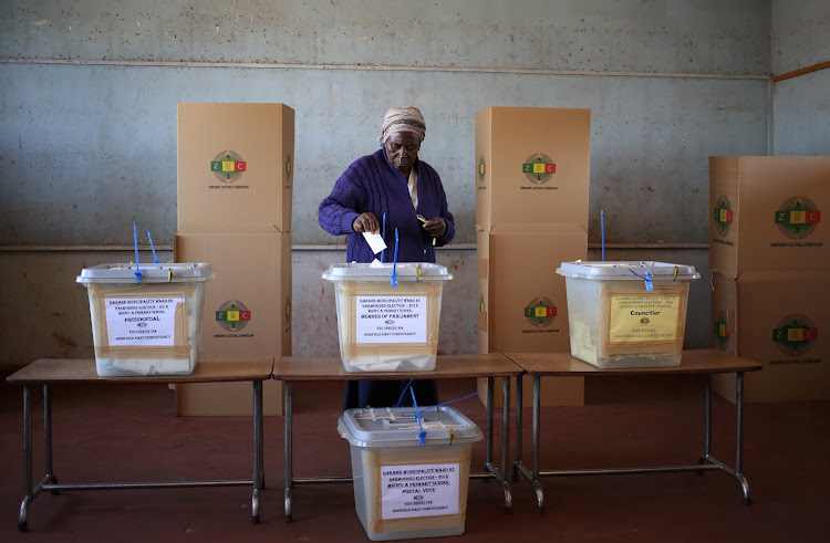 A voter casts her ballot in the general elections in Harare, Zimbabwe, July 30, 2018.