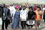 PAYING RESPECTS: King Buyelekhaya 
      
       Dalindyebo, middle, leads a delegation of Thembu royals to Nelson Mandela's Qunu home to pay their last respects a day before  
      
       his funeral on December 15 
      
       last year
      
      
        
      
      PHOTO: Elmond Jiyane/GCIS
