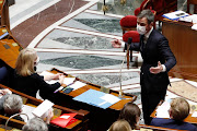 French Health Minister Olivier Veran, wearing a protective face mask, speaks during the questions to the government session at the National Assembly in Paris amid the coronavirus disease (Covid-19) outbreak in France, March 16, 2021. 