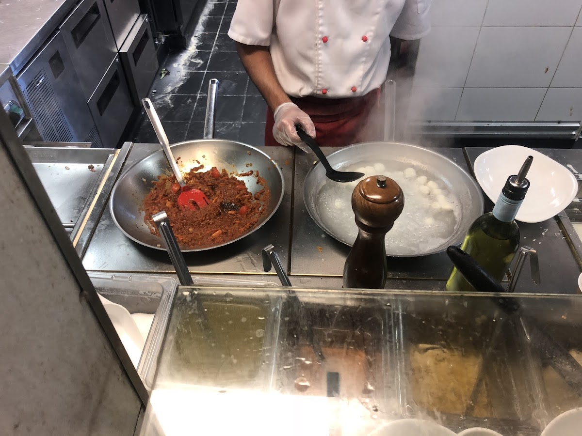 They cook the gnocchi in its own water and own pan separate from the other pasta. Gnocchi bolognese.