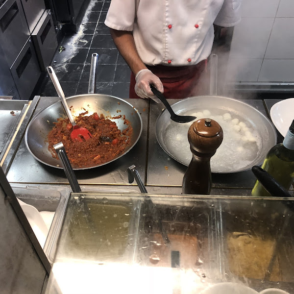 They cook the gnocchi in its own water and own pan separate from the other pasta. Gnocchi bolognese.