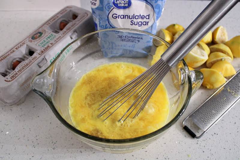 Whisk Sugar, Eggs, Lemon Zest, And Lemon Juice.